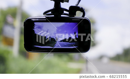 Camera on the front of a car Background Cars on the road and clouds in the sky. Camera on the front of a car Background Cars on the road and clouds in the sky. 68215555