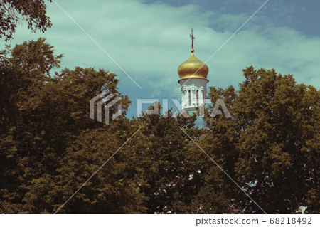 The dome of the Orthodox church over the trees. 68218492