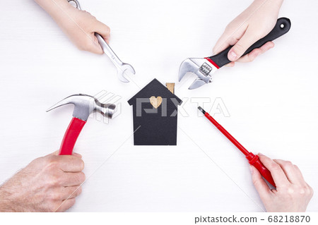 Repair tools around a model of a house on a light Repair tools around a model of a house on a light 68218870