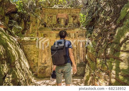 Man tourist on the background of Beautiful Marble mountains and Da Nang, Vietnam Man tourist on the background of Beautiful Marble mountains and Da Nang, Vietnam 68218932