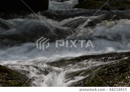 A mountain stream with abundant water and a violent flow A mountain stream with abundant water and a violent flow 68219915