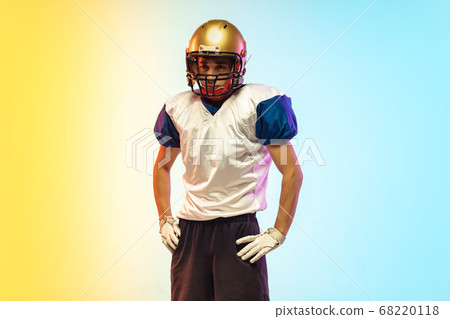 American football player isolated on gradient studio background in neon light American football player isolated on gradient studio background in neon light 68220118