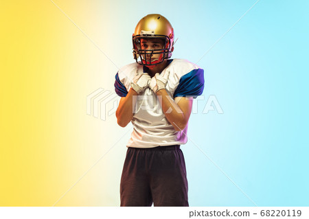 American football player isolated on gradient studio background in neon light American football player isolated on gradient studio background in neon light 68220119