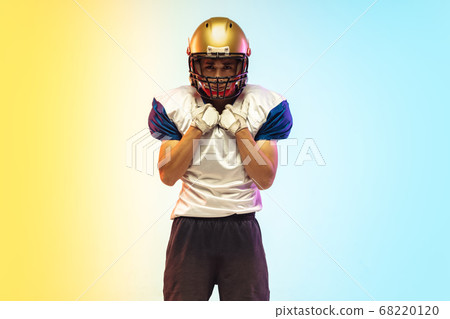 American football player isolated on gradient studio background in neon light American football player isolated on gradient studio background in neon light 68220120