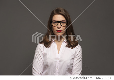 Young woman with glasses and red lips 68220285