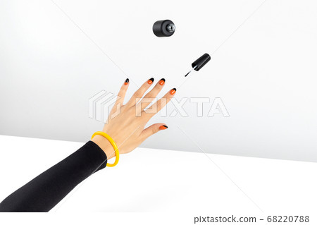 Creative composition with woman's hands and flying nail varnish Creative composition with woman's hands and flying nail varnish 68220788