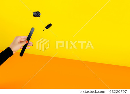 Creative composition with woman's hands and flying nail varnish Creative composition with woman's hands and flying nail varnish 68220797
