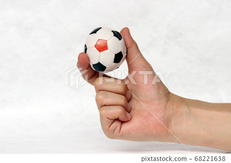 Mini ball of football in hand and one black point of football is China flag. Mini ball of football in hand and one black point of football is China flag. 68221638