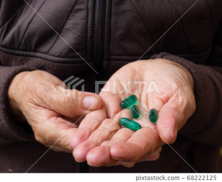 Close up shot of a hand holding several medicines Close up shot of a hand holding several medicines 68222125