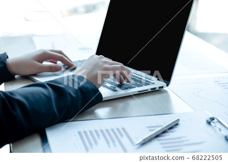 Businesswoman calculating financial graph showing results in the office Businesswoman calculating financial graph showing results in the office 68222505