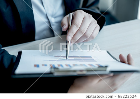 Businesswoman calculating financial graph showing results in the office Businesswoman calculating financial graph showing results in the office 68222524