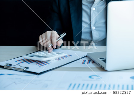 Businesswoman calculating financial graph showing results in the office Businesswoman calculating financial graph showing results in the office 68222557