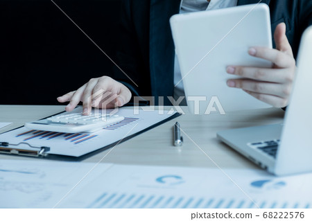 Businesswoman calculating financial graph showing results in the office Businesswoman calculating financial graph showing results in the office 68222576