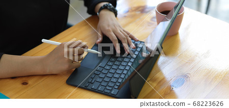 Female hands using digital tablet with keyboard Female hands using digital tablet with keyboard 68223626