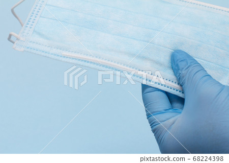 Dentist's hand in glove with protective mask. 68224398