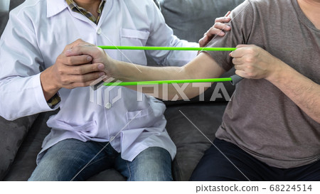 Doctor physiotherapist treating rehabilitation arm 68224514