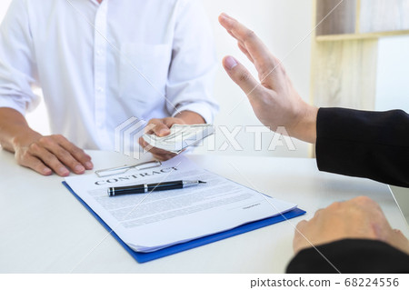 Businessman refusing receive bribe money in the Businessman refusing receive bribe money in the 68224556