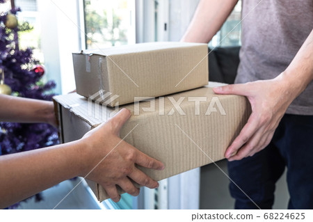 Young Delivery man deliver box parcel package and Young Delivery man deliver box parcel package and 68224625
