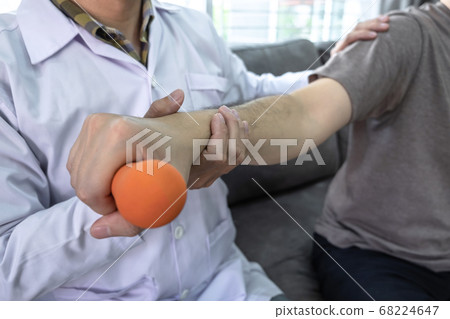 Doctor physiotherapist treating rehabilitation arm 68224647
