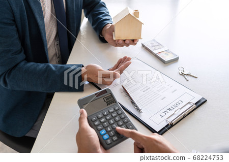 Real estate agent are presenting home loan and 68224753