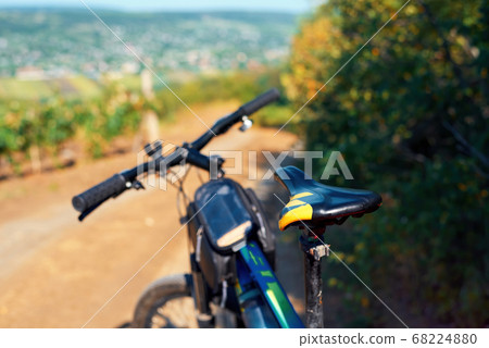 Parked bicycle on a country road 68224880