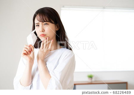 Young woman worrying about rough skin due to mask toothache 68226489