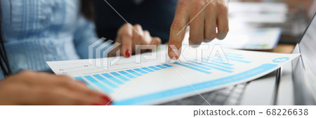 Businessman shows business performance on graph closeup Businessman shows business performance on graph closeup 68226638