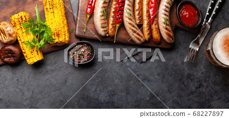 Grilled sausages and vegetables with spices and 68227897