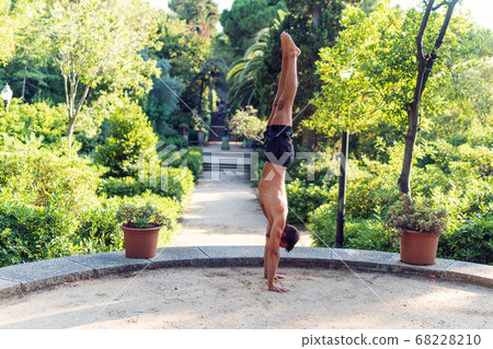 Fitness man exercising handstand in the park. Street workout 68228210