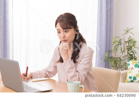 A young woman making a web conference using a laptop computer in telework A young woman making a web conference using a laptop computer in telework 68230090