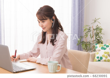 A young woman making a web conference using a laptop computer in telework A young woman making a web conference using a laptop computer in telework 68230091