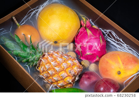 Wooden box with exotic fruits in smoke Wooden box with exotic fruits in smoke 68230258