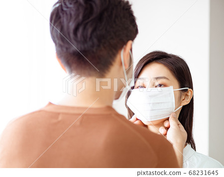Young asian woman and man wearing Surgical mask at Young asian woman and man wearing Surgical mask at 68231645