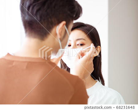 Young asian woman and man wearing Surgical mask at 68231648