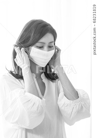 Young asian woman wearing Surgical mask at home in black and white 68231819