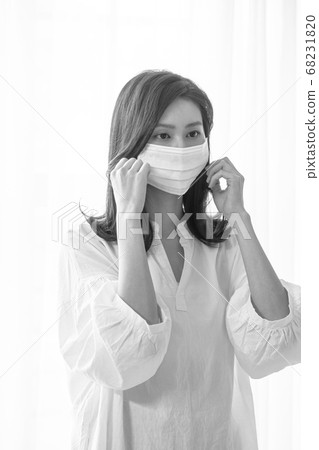 Young asian woman wearing Surgical mask at home in black and white 68231820