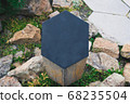 Closeup black metal sign at green grass background, nameplate with a space for your text, copyspace, empty space for inscription 68235504