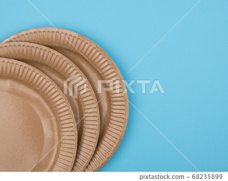 Cardboard plates on a blue background. The view 68235899