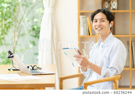 A young man doing telework in the living room 68236244
