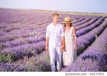 Family in lavender flowers field at sunset in white dress and hat Family in lavender flowers field at sunset in white dress and hat 68237001