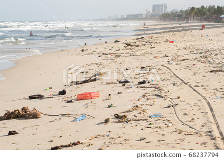 Beach of Da Nang City, Vietnam, after storm, covered with garbage. This is the South China Sea of the Pacific Ocean. Beach of Da Nang City, Vietnam, after storm, covered with garbage. This is the South China Sea of the Pacific Ocean. 68237794