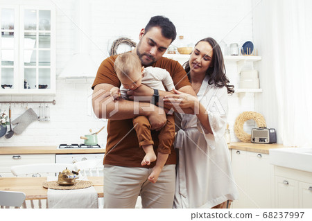 young family with little cute son on kitchen in morning happy smiling, lifestyle people concept 68237997