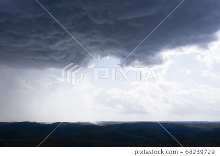 A severe thunderstorm and rain over a valley in The Blue Mountains in Australia A severe thunderstorm and rain over a valley in The Blue Mountains in Australia 68239729