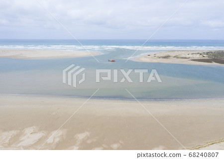 Aerial view of a sand dredger boat at the mouth of the Murray River in South Australia 68240807