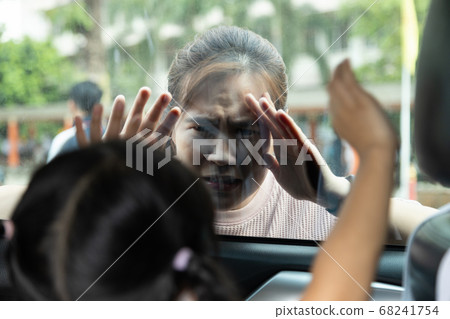 Asian mother forgot her kid daughter inside of her car in parking outdoor,trapped inside motor vehicles,danger of suffocation,overheating in car for child girl,causing death or loss of consciousness Asian mother forgot her kid daughter inside of her car in parking outdoor,trapped inside motor vehicles,danger of suffocation,overheating in car for child girl,causing death or loss of consciousness 68241754