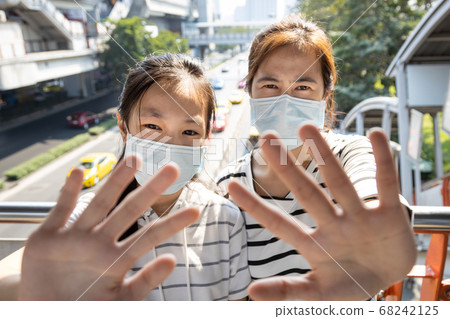Two asian people,campaign wearing protective mask before leaving the home in risk areas of disease,smog,dust,air pollution,protection infection of coronavirus NCoV 2019,pandemic of Covid-19 virus Two asian people,campaign wearing protective mask before leaving the home in risk areas of disease,smog,dust,air pollution,protection infection of coronavirus NCoV 2019,pandemic of Covid-19 virus 68242125