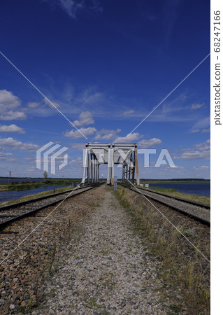 Distant twin railway bridge against sky 68247166