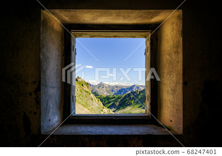 Mountain seen from an old window 68247401
