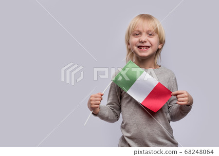 Blond boy holding flag of Italy and laughs. Study Blond boy holding flag of Italy and laughs. Study 68248064