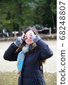 Women who peace sign with both hands 68248807